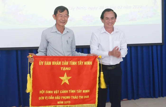 Ông Nguyễn Hữu Ngân- Phó giám đốc Sở Nội vụ, Phó Chủ tịch thường trực Hội đồng Thi đua - Khen thưởng tỉnh trao cờ thi đua cho Hội Sinh vật cảnh.